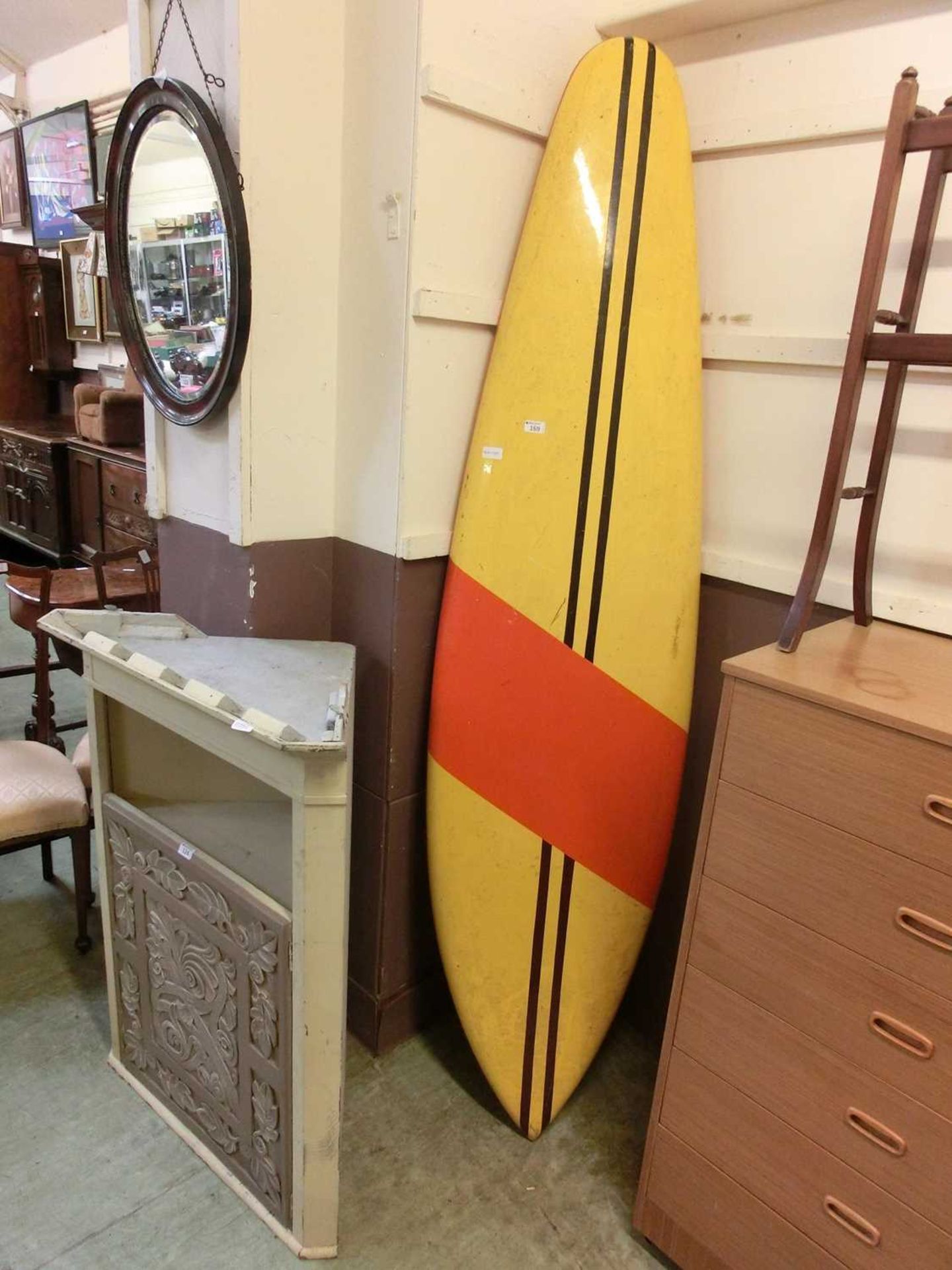 A yellow and red surfboard