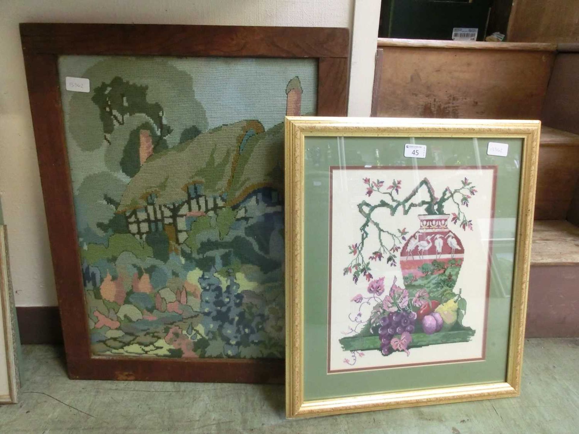 Two framed and glazed tapestries to include cottage scene and still life