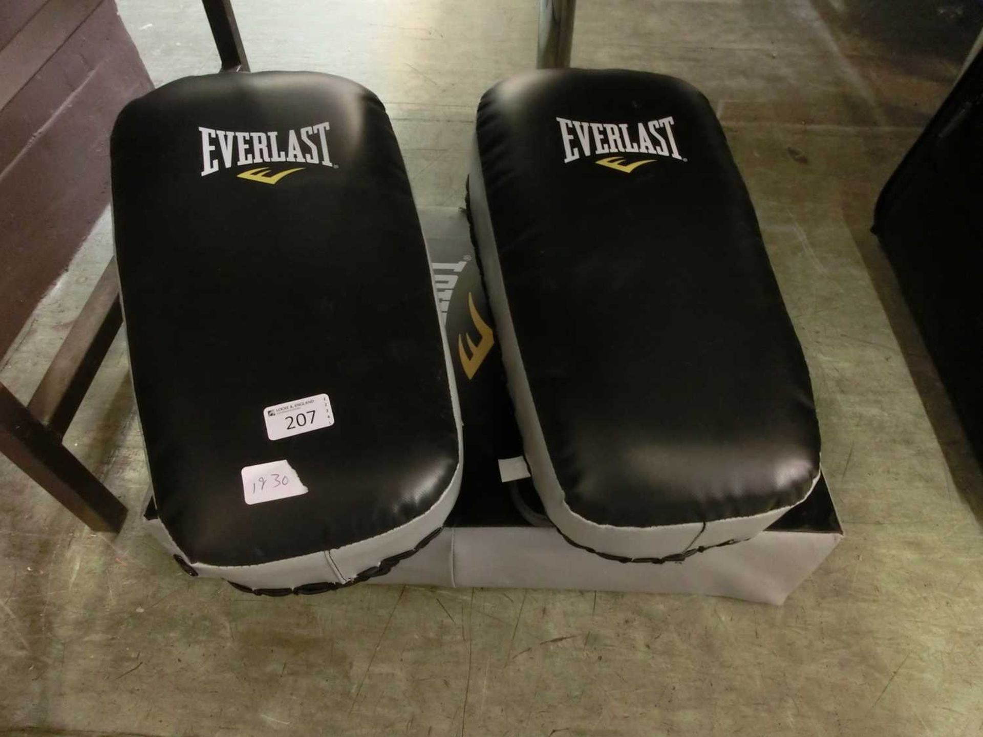 A set of two Everlast boxing training pads along with a kick shield