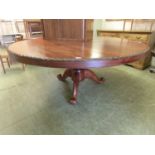 A modern hardwood circular dining table