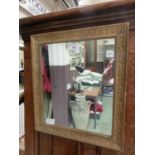 An ornate gilt framed mirror