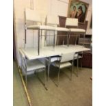 A mid-20th century design white Formica topped extending kitchen table along with a set of six white