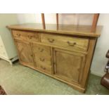 A modern parquetry sideboard, top over two drawers and two cupboard doors flanking three further