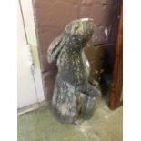 A composite stone garden ornament in the form of a rabbit