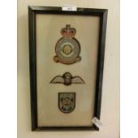 A framed and glazed display of pre military badges