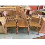 A pair of kitchen chairs along with a Windsor style chair