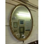 An oval gilt framed bevel glass mirror