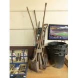 A large quantity of long handled garden tools to include forks, spades, picks, etc