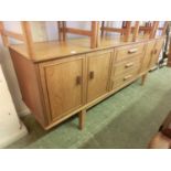 A mid-20th century teak sideboard, three central drawers flanked by cupboard doorsDimensions: H: