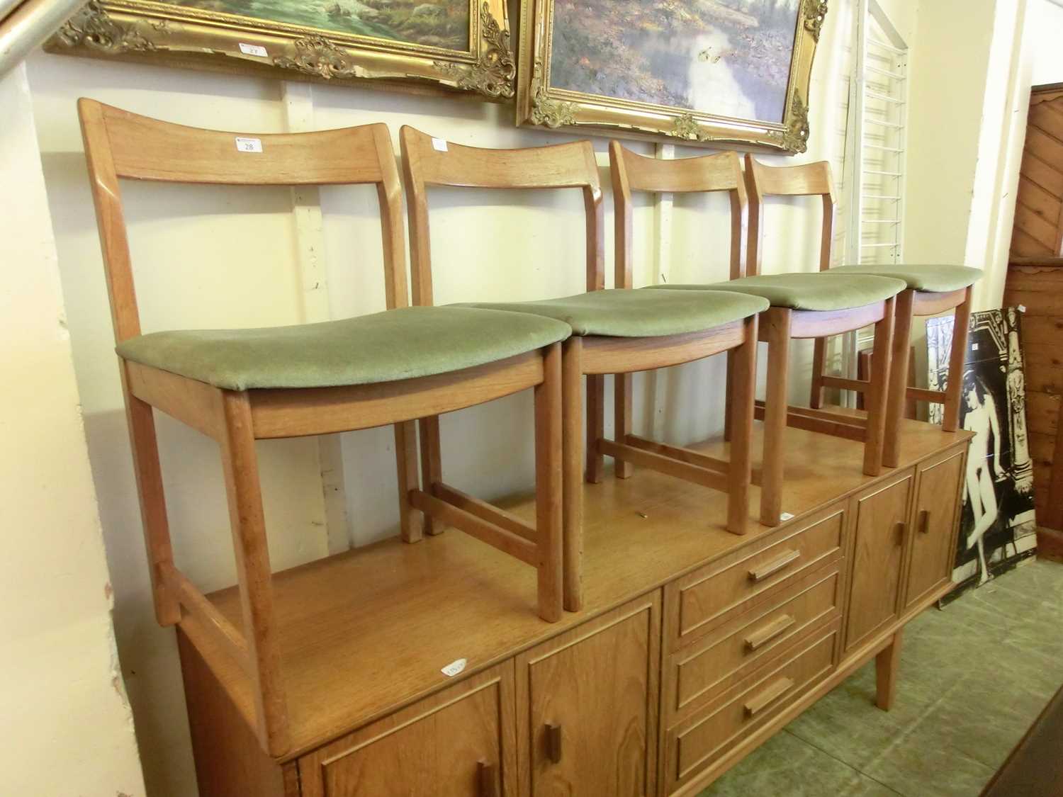 A set of four mid-20th century teak dining chairs