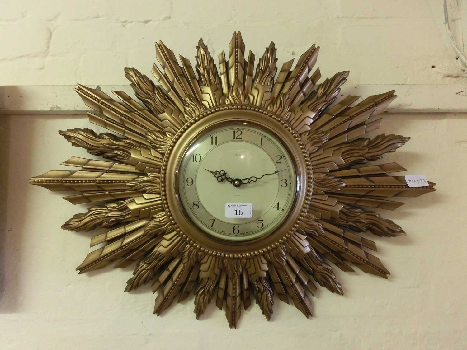 A sunburst wall clock by Smiths