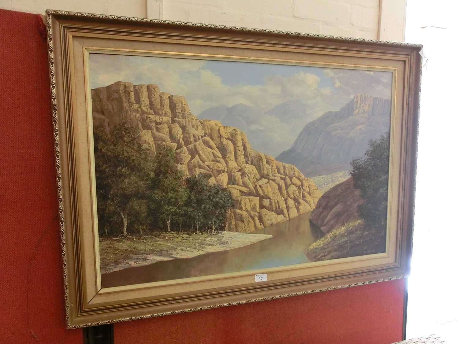 A gilt framed oil on board of river through mountain scene signed R.C.Roelofsz