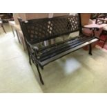 A wooden green painted garden bench with metalwork frame