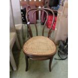 A bent wood chair with bergere seat