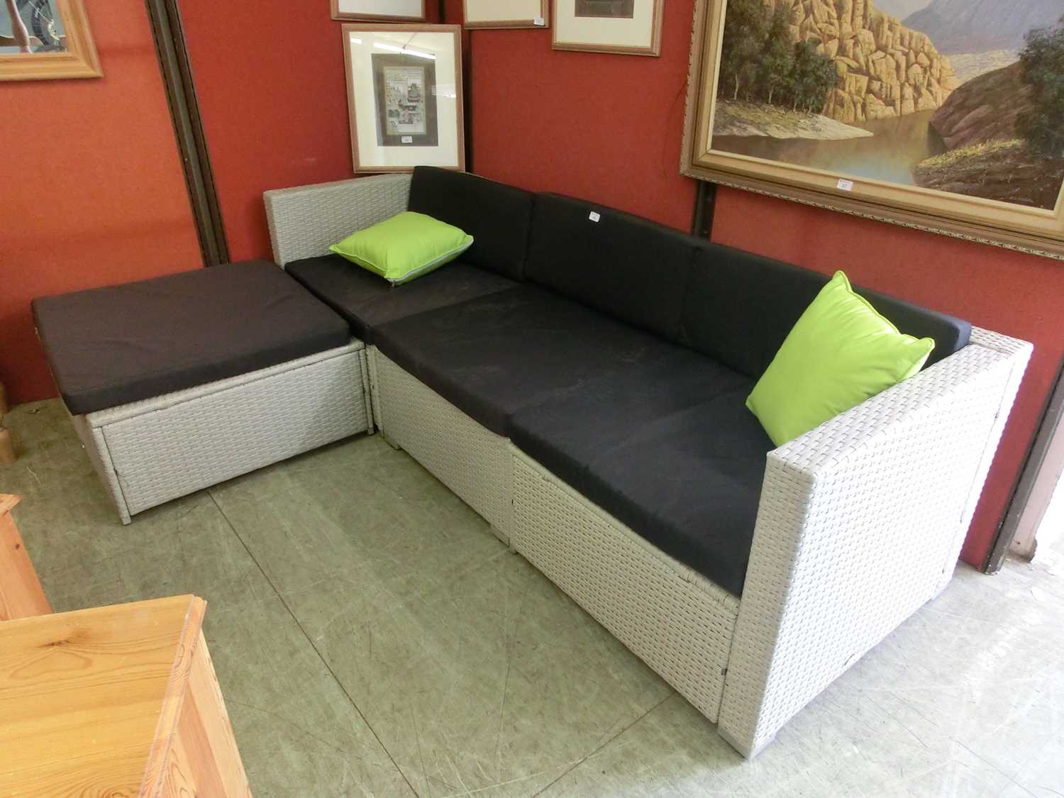 An Outsunny garden seat comprising of two corner sections, a middle section and a footstool