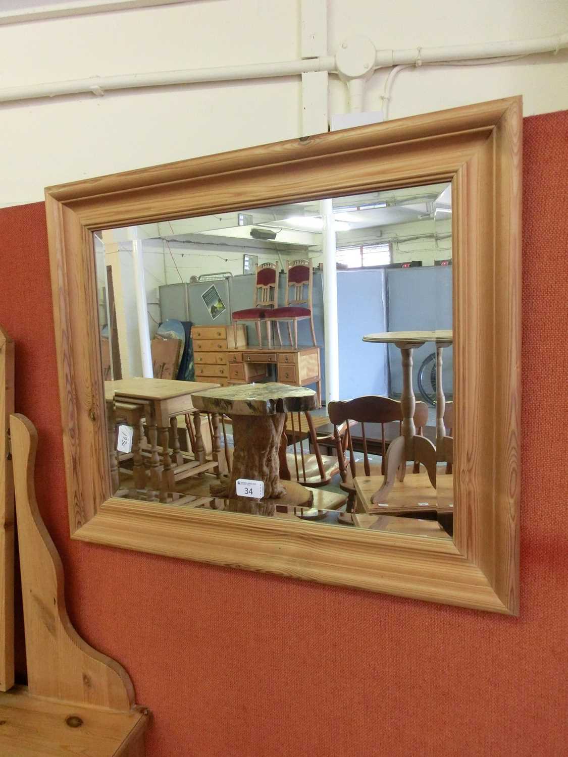 A modern pine framed bevel glass mirror