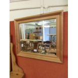 A modern pine framed bevel glass mirror