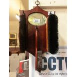 A mid-20th century wall mounted mirror and brush set