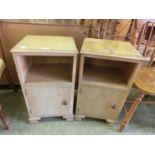 A pair of bleached walnut bedside cupboards