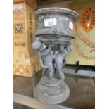 A late 19th century cast metal planter with cherub designCracks and chips throughout. Top somewhat