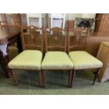 A set of three Edwardian rosewood, marquetry and boxwood strung dining chairs