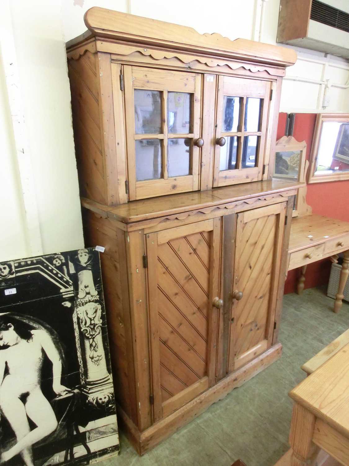 A late 19th century pine cabinet, the super structure with two glazed doors over two cupboard doors