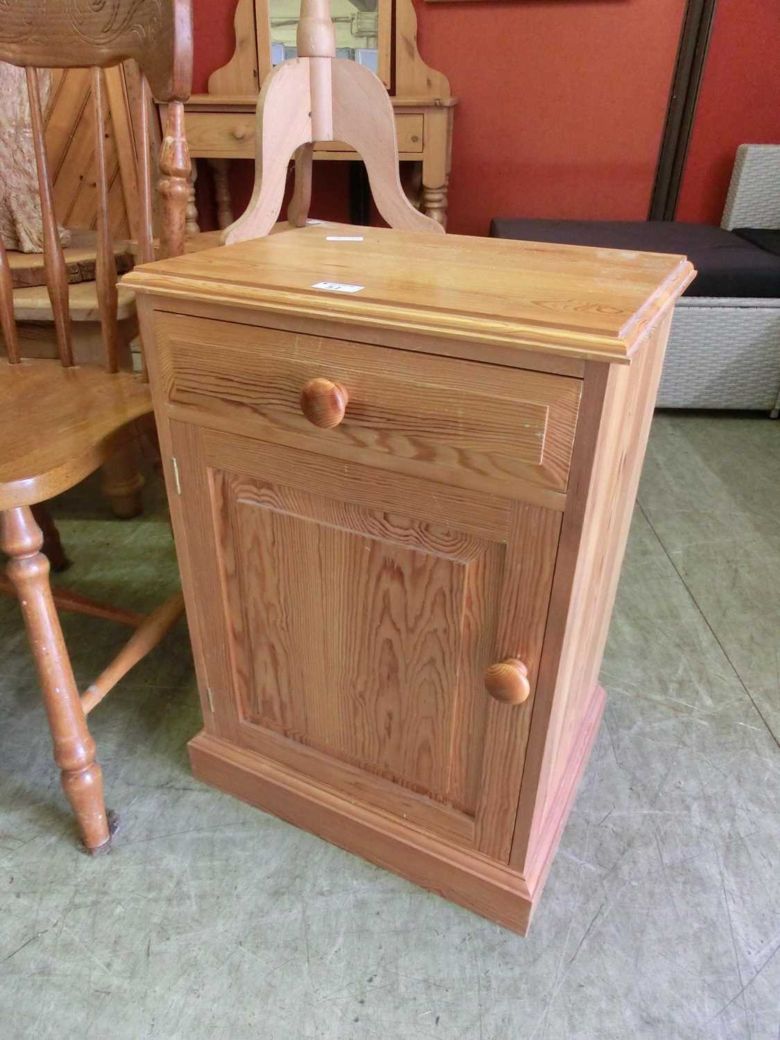 A modern pine bedside cupboard