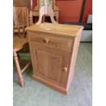 A modern pine bedside cupboard