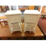 A pair of white occasional tables, single drawer over wicker basket