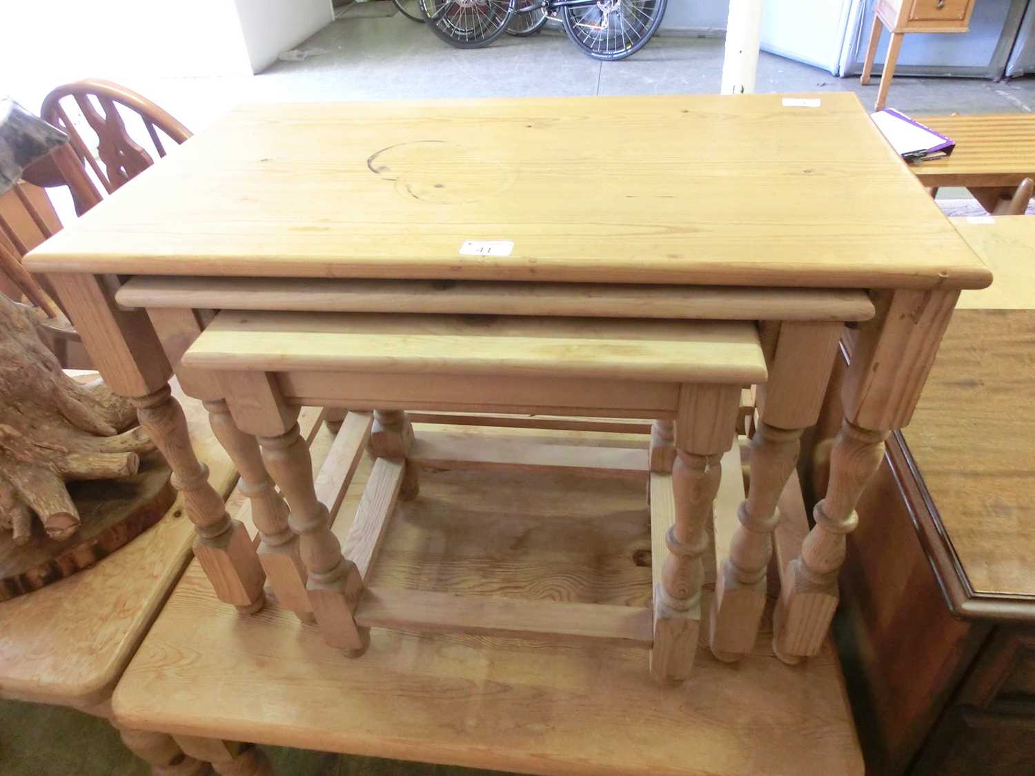 A nest of three pine occasional tables