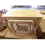 A nest of three pine occasional tables