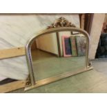 A silver framed over mantle mirror