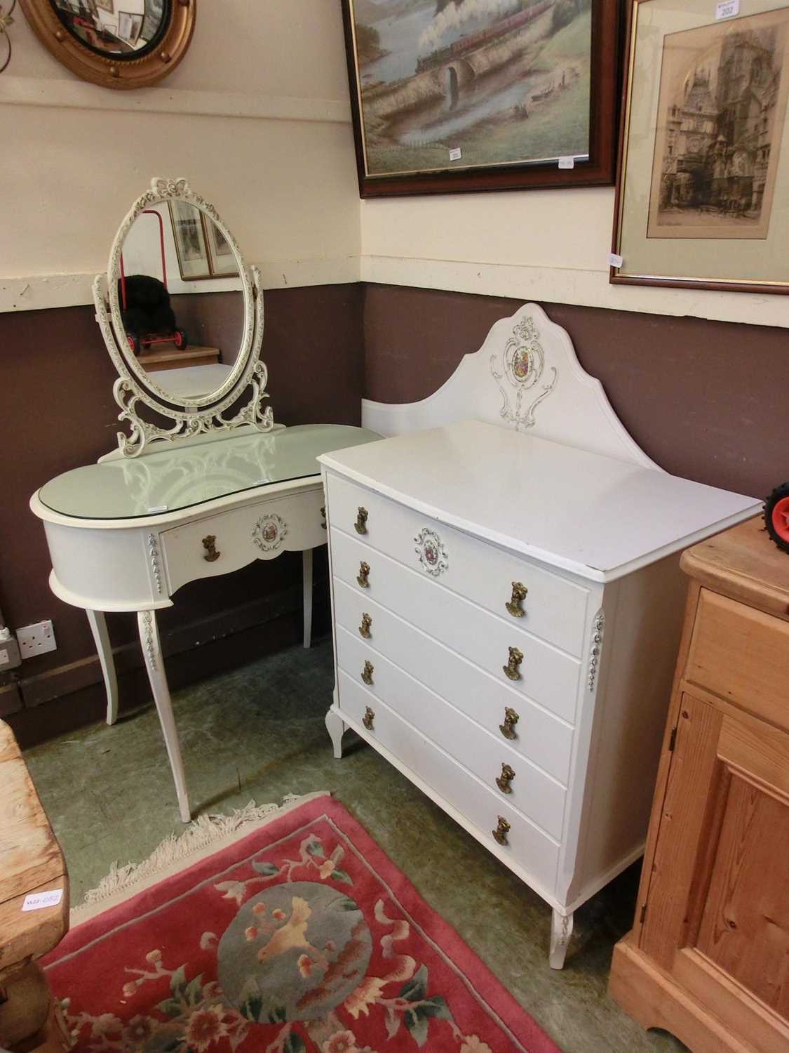 A cream painted chest of five drawers together with a cream painted gilt decorated dressing table