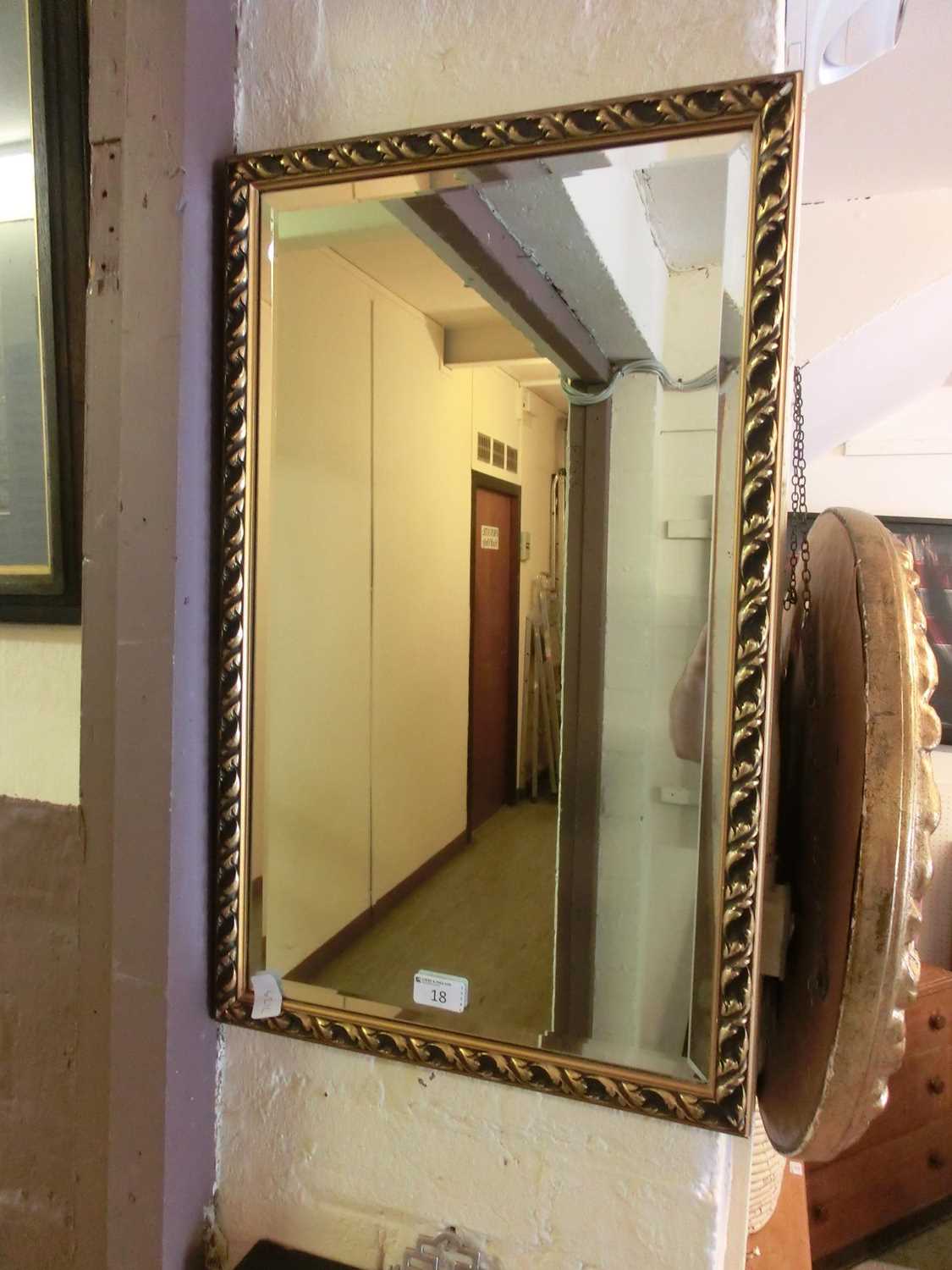 A rectangular gilt framed bevel glass wall mirror