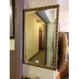 A rectangular gilt framed bevel glass wall mirror