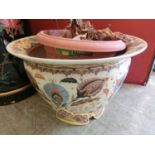 A reproduction ceramic planter with floral design