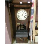 An early 20th century oak cased clocking-in clock