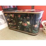 An oriental black lacquer hand painted cabinet having a set of four drawers beside two drawers