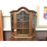 A reproduction oak wall mounted glazed cabinet