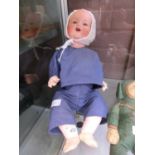 A mid-20th century ceramic headed doll, having 'AM Germany 35/6K' embossed to back of neck