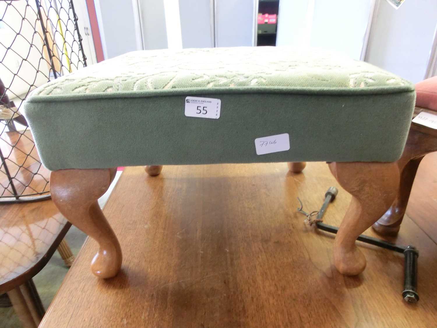 A reproduction green upholstered foot stool with cabriole legs