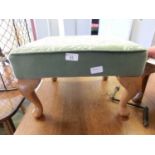 A reproduction green upholstered foot stool with cabriole legs