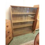 A mid-20th century teak bookcase having sliding glazed doorsNo apparent damage. Minor stains