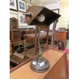 An early 20th century brass and copper desk lamp