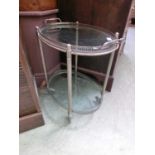 An early 20th century white metal and glass two tier trolley with removable tray to top