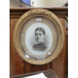 A Victorian gilt framed oval photographic print of lady