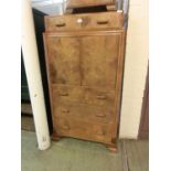 An early 20th century walnut tall boy, single drawer over two cupboard doors and three further