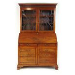 A late 18th century mahogany bureau bookcase, the dentil cornice over two astragal glazed doors