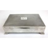 A silver cigar box with engine turned lid and bracket feet. Hallmarks rubbed, l. 14.5 cm