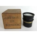 A military aircraft reconnaissance lens marked '20 in. F6.3 EE189268'. Housed in packing crate